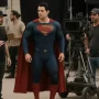 Nicholas Hoult's Knee Surgery Forces Superman Actor to Cancel New York Comic Con Appearance Superman actor in costume on movie set with visible knee support