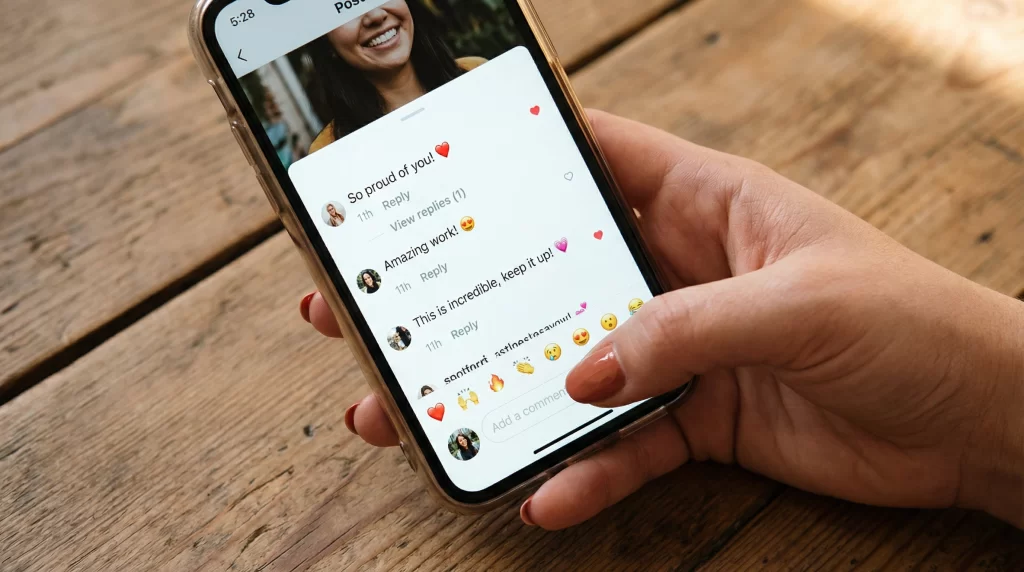 A smartphone screen showing positive social media comments and heart emoji reactions from fans