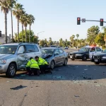 Severe car crash scene at an intersection in California involving a large SUV and another vehicle