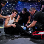 Singer receiving medical attention on stage during live performance