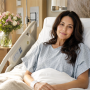 A female television personality resting in a hospital bed recovering from minimally invasive spine surgery