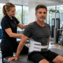 Celebrity recovering after back surgery with physical therapist