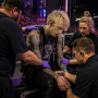MGK receiving medical attention after stage dive at a live concert