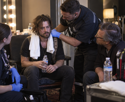Folk rock singer recovering backstage after onstage collapse