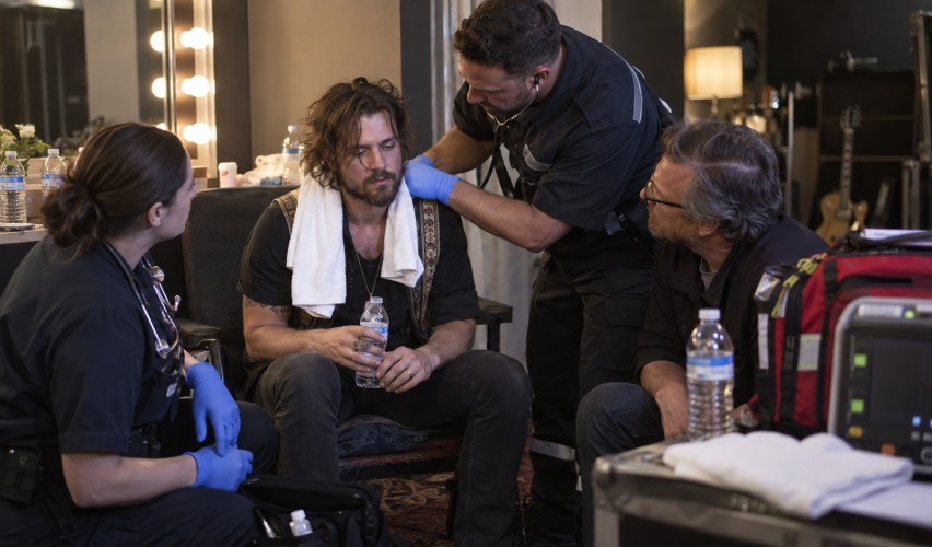Folk rock singer recovering backstage after onstage collapse