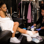 Pop singer recovering from foot injury backstage after concert