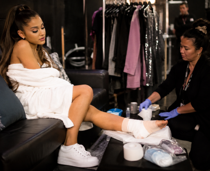 Pop singer recovering from foot injury backstage after concert