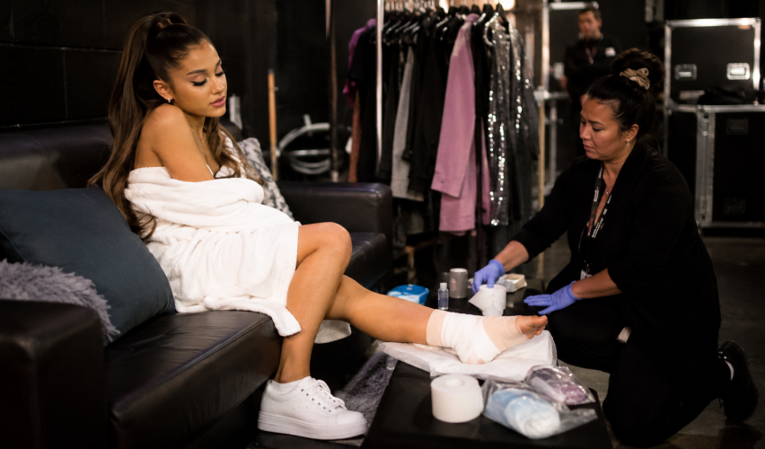 Pop singer recovering from foot injury backstage after concert
