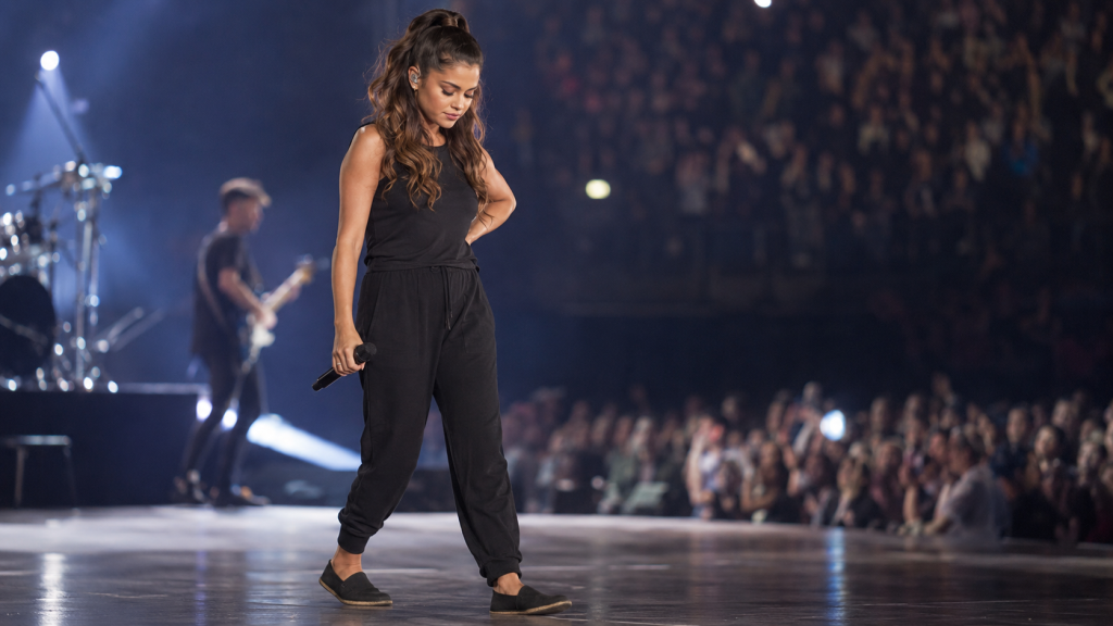 Singer performing in comfortable footwear after foot injury