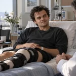 Actor receiving medical attention for a knee injury on a movie set