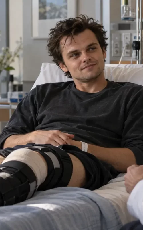 Actor receiving medical attention for a knee injury on a movie set